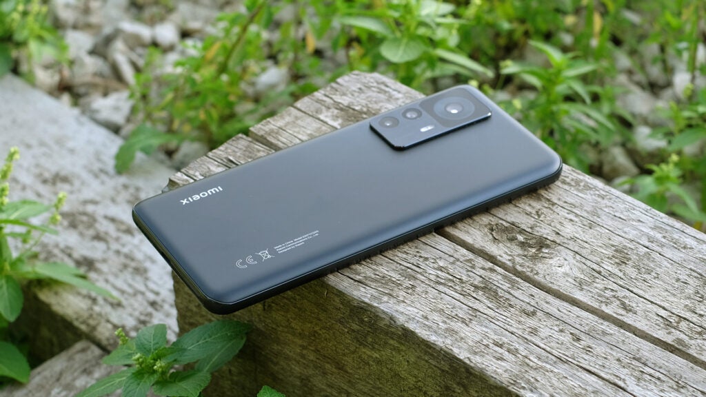 The Xiaomi 12T phone on a wooden surface